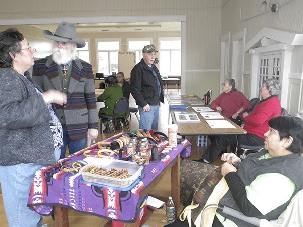 Sunsets West Co-op board member Jerry George (hat) greets people at the annual Community Celebration in the Sekiu Community Center. Photo by Donna Barr