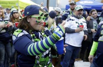To inspire you — a fan takes a picture with a phone while tailgating before the game between the Seahawks and the Arizona Cardinals on Nov. 23 in Seattle.