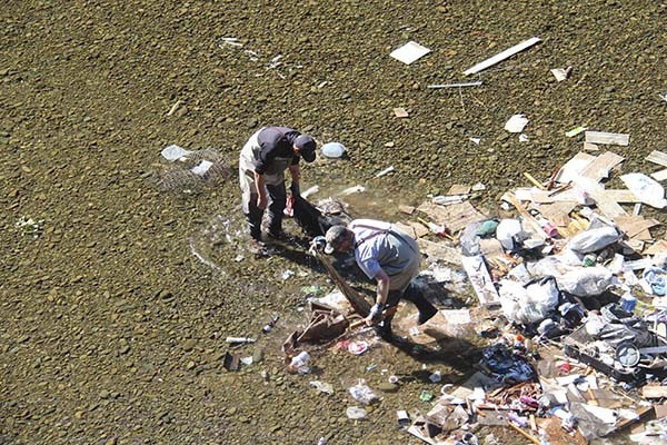 Quileute Natural Resources is on the scene this morning cleaning up an illegal dump in the South Fork of the Calawah River near Klahanie Campground.