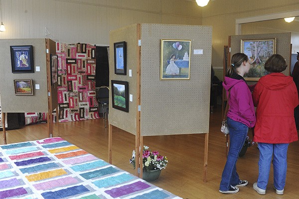 Viewers take in the Messy Palettes art show at the Sekiu Community Center.