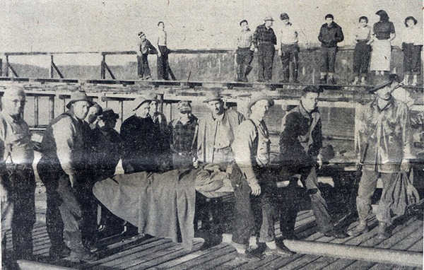 LaPush residents look on as Sandy is taken off the surf boat. From left