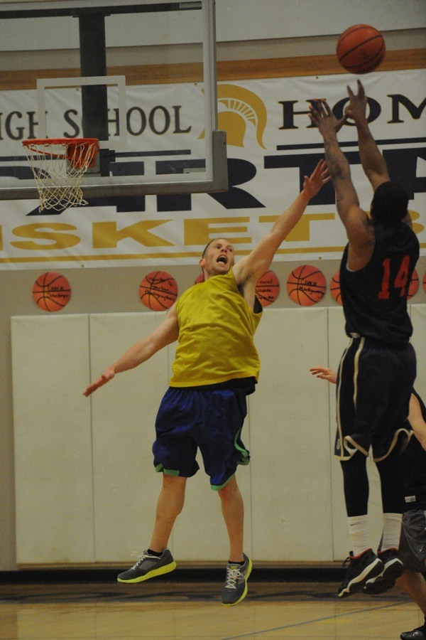 Rick Gooding of Olympic Sporting Goods in Forks defends against Port Angeles Swimmin' Hole on Saturday. Olympic Sporting Goods defeated Swimmin' Hole 65-57 during the Nate Crippen Memorial Tournament at Forks High School.