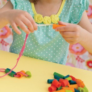 Making a macaroni necklace....