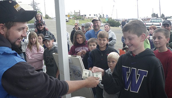 Derby chairman Adam Campbell awarded the first place prize to Aidan McKinney with lots of youths and parents in the background after the 2013 Derby.