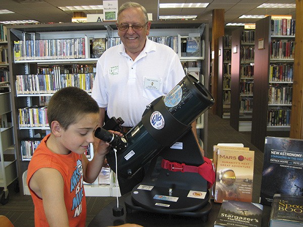 Forks Elks Lodge 2425 made a generous donation to the North Olympic Library System. The funds were used to purchase three telescopes for library users to check out and explore the universe. The donation also was used to purchase astronomy books and fund a program at the Forks Library on Aug. 22 featuring NASA ambassador Ron Hobbs. Here Elk member Glenn King and his grandson Aden Mueller are looking up! For more information about the telescopes or astronomy programs
