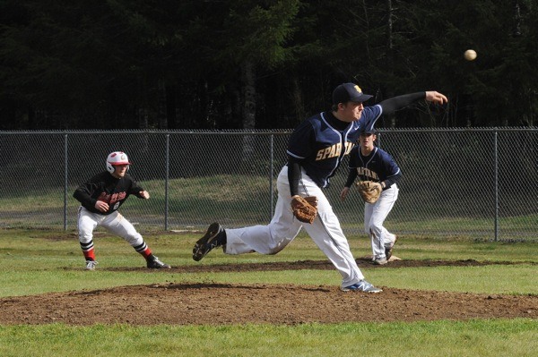 Forks pitcher Nate Gimlin delivers to the plate while Spartan first-baseman Reece Moody holds a Tenino runner at first.
