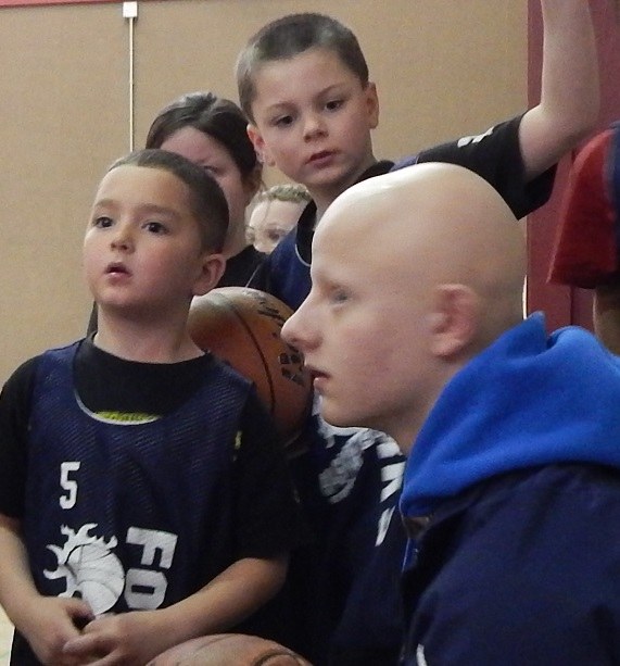 Coach Colton Raben listens to his Spartans team plead for more playing time as they get ready for the last few minutes of the last game of the season.