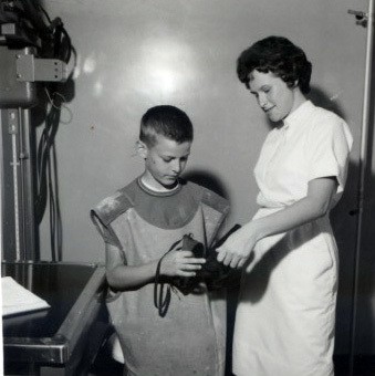 Around 1962ish nurse Jay Reise shows a young Howard Baron some of the hospital equipment during a field trip to the hospital.