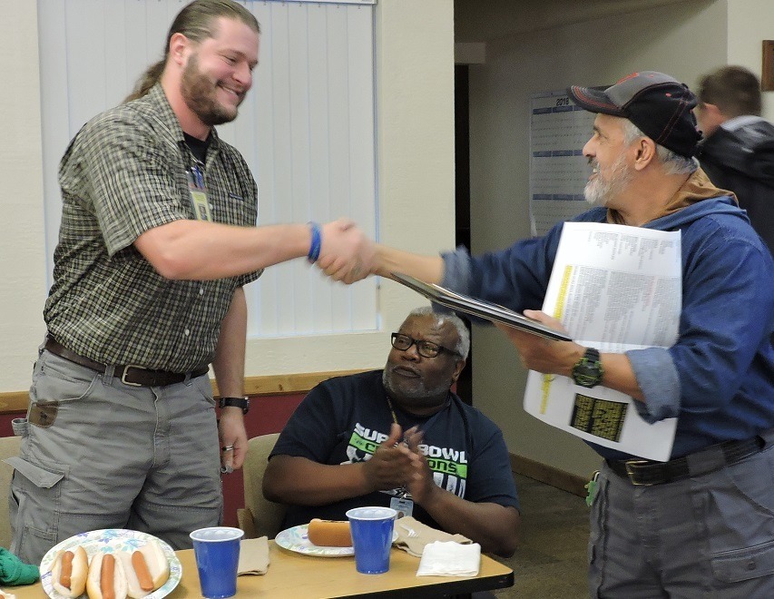 OCC Superintendent John Aldana (right) congratulates David Muckley as the winner of the hot dog eating contest. Submitted Photo