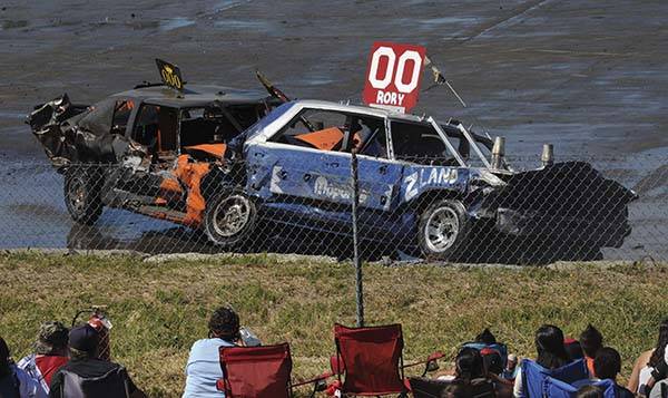Eric Anderson in the 000 car runs brother Rory Anderson into the retaining wall during the Demo Derby held at the Tillicum Park Arena. Photo by Lonnie Archibald