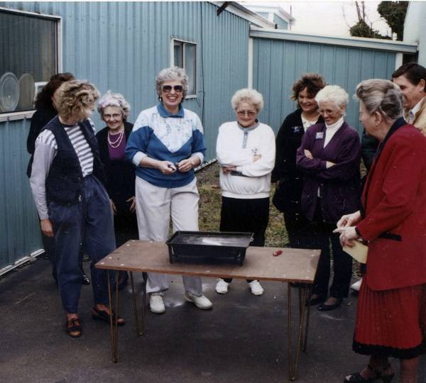 Ginger Haberman all smiles in the center of the photo, burning the mortgage!