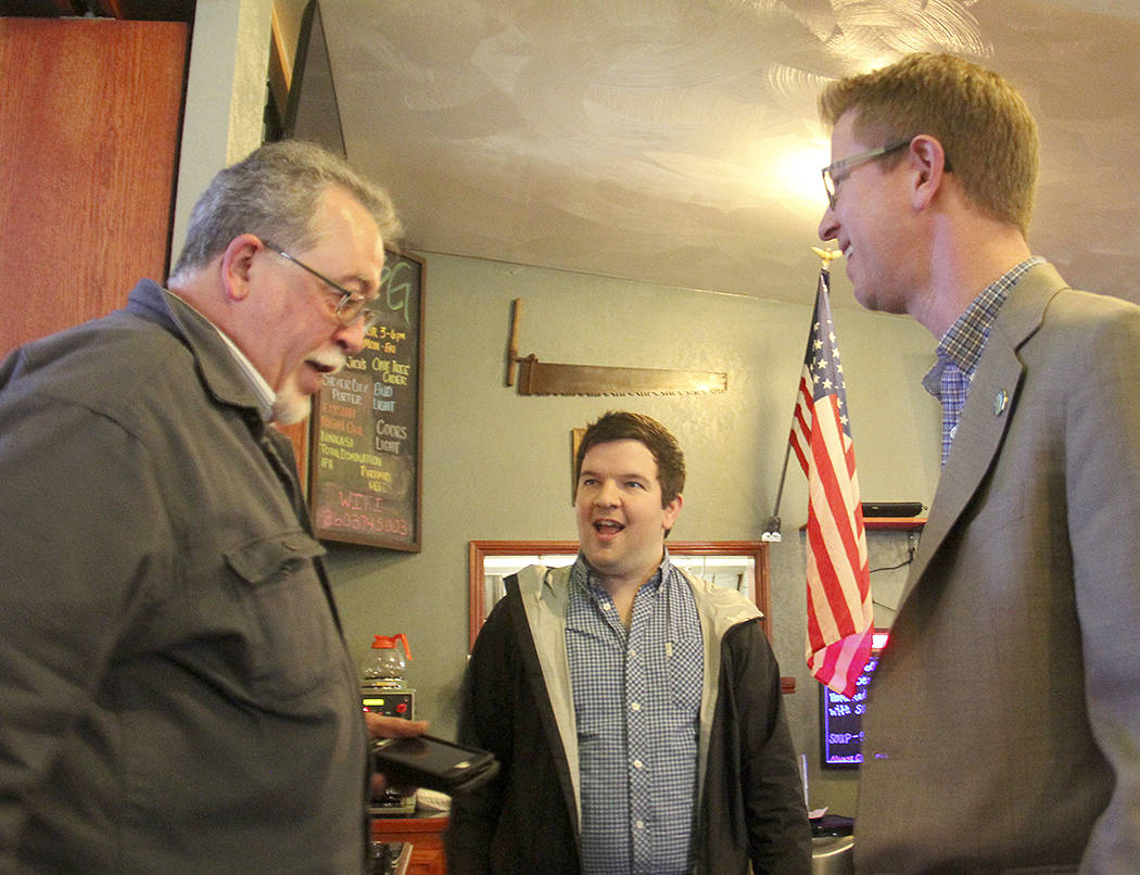 Congressman Derek Kilmer, right, speaks with Quileute Oceanside Resort manager Larry Donnelly, left, as Kilmer’s Communications Director, Tim Biba, looks on after the Forks Chamber of Commerce meeting adjourned last Wednesday afternoon in Forks. Photo Christi Baron