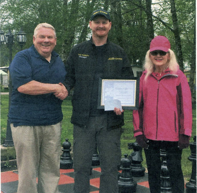 Jerry and Margaret King, owners of Alder Grove present Joey Roberts, manager, with an $1,800 check and a Certificate of Appreciation for his 18 years of service to Alder Grove. Submitted Photo