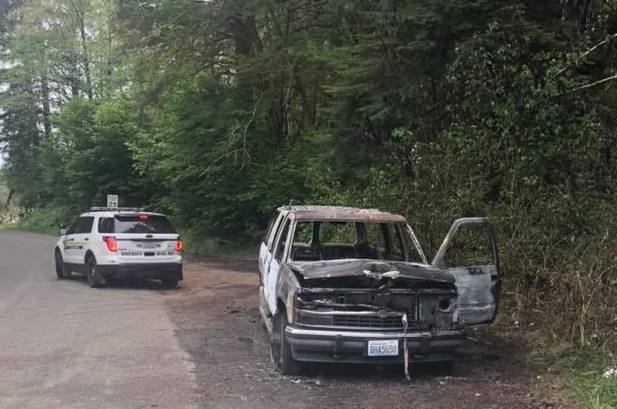 Clallam County Sheriff’s Department investigates this burned-out vehicle on Shuwah Rd. Submitted Photo