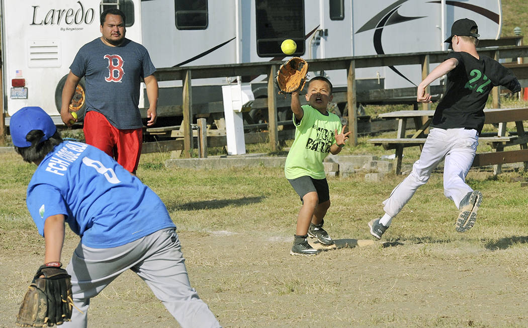Ryan Rancourt playing for Eagle Repair and Towing was safe at first as Hoh River pitcher Gabe Barrows throws to first baseman Cordell Horejsi. Eagle Repair won this contest during the kids 13 and under softball tournament played at La Push during Quileute Days. Photo by Lonnie Archibald