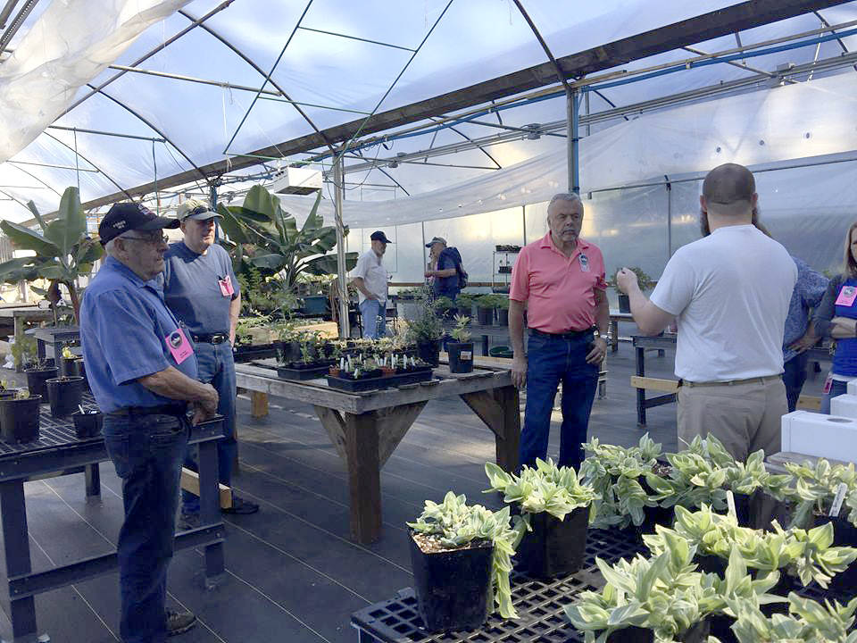 Community members get a look at the greenhouse at Olympic Corrections Center during a tour held at the facility on July 12.