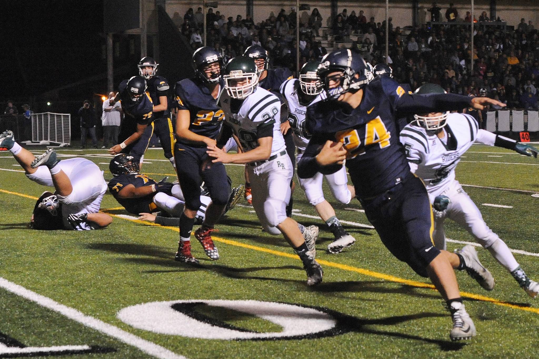 Spartan Colby Demorest (24) runs around the end for a good gain down to the one-yard line.