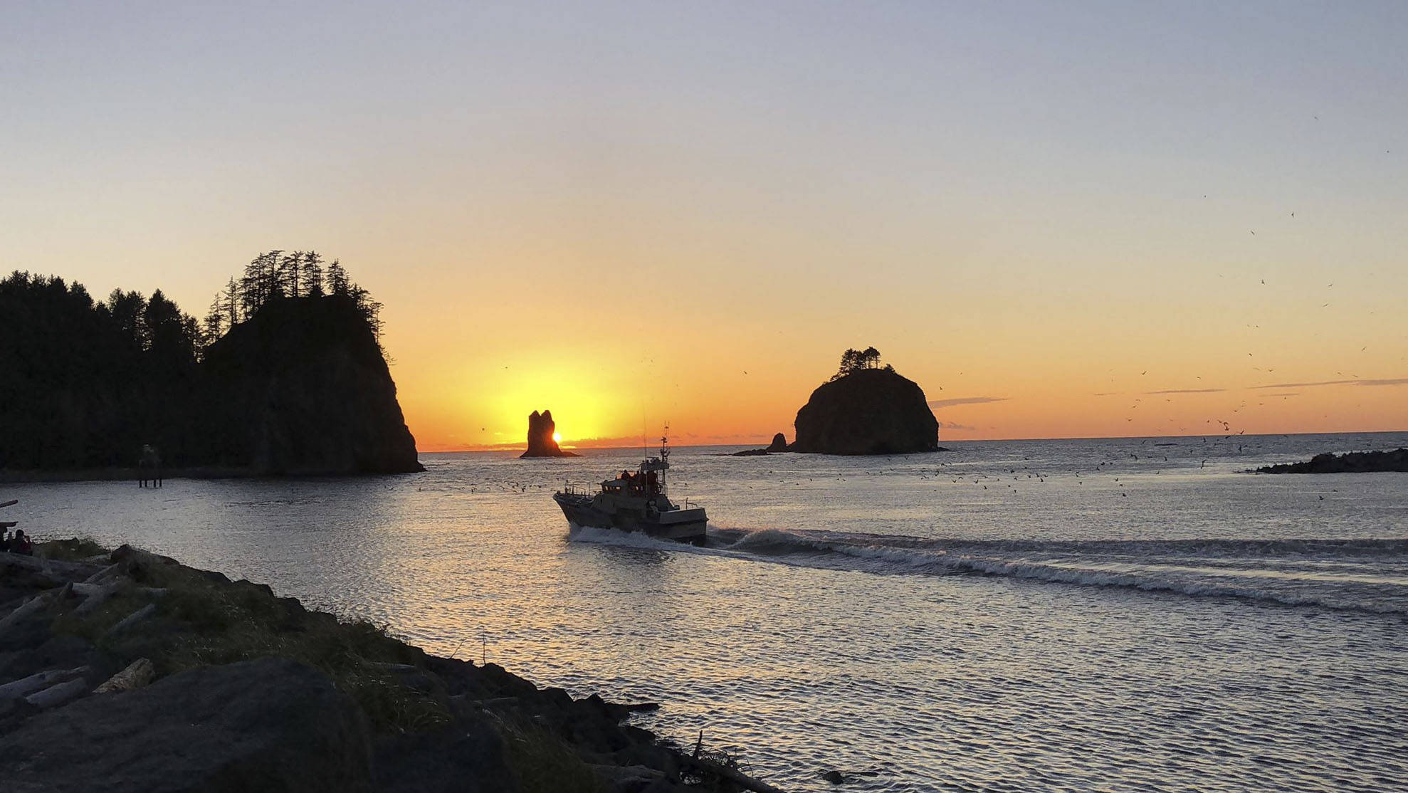As the sun sets at La Push the USCG Station Quillayute River boat crew heads out in calm waters, which is not always the case. This week Hickory Shirt-Heritage Days salutes them and recognizes their important role in our community. Photo John Leavitt