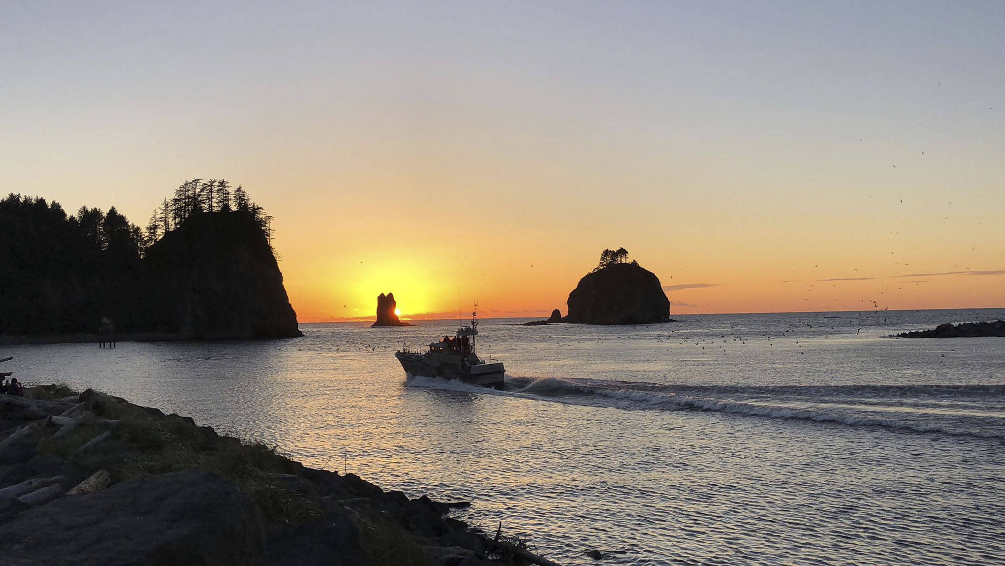 As the sun sets at La Push the USCG Station Quillayute River boat crew heads out in calm waters, which is not always the case. This week Hickory Shirt-Heritage Days salutes them and recognizes their important role in our community. Photo John Leavitt