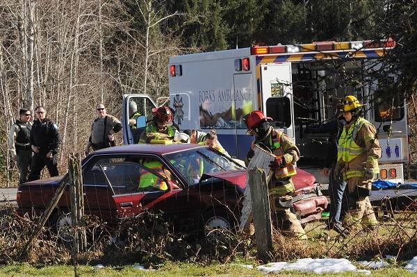 Forks medics work to remove the victim from a vehicle involved in a two-vehicle collision Friday, March 1 at approximately 2 p.m., 91-year-old Gene Spaulding was transferred to the Forks Hospital and was airlifted. This occurred at approximately at the junction of Highway 101 and Beaver Ave. Several law enforcement agencies were on the scene as well as Beaver Fire crews. Photos by Lonnie Archibald