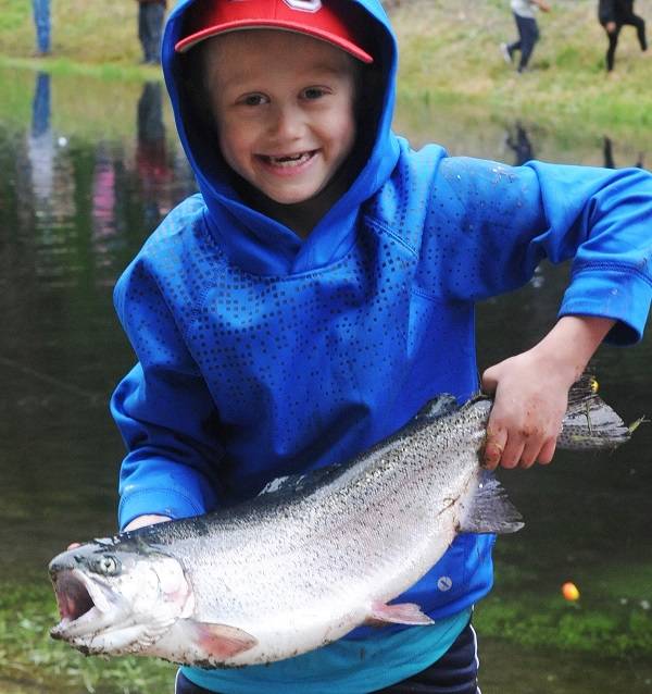 Eight-year-old Hunter Schmitz was a happy fisherman with this large trout he caught at the Bogachiel Rearing Pond during the annual Kids Fishing Day Sunday. Photo by Lonnie Archibald