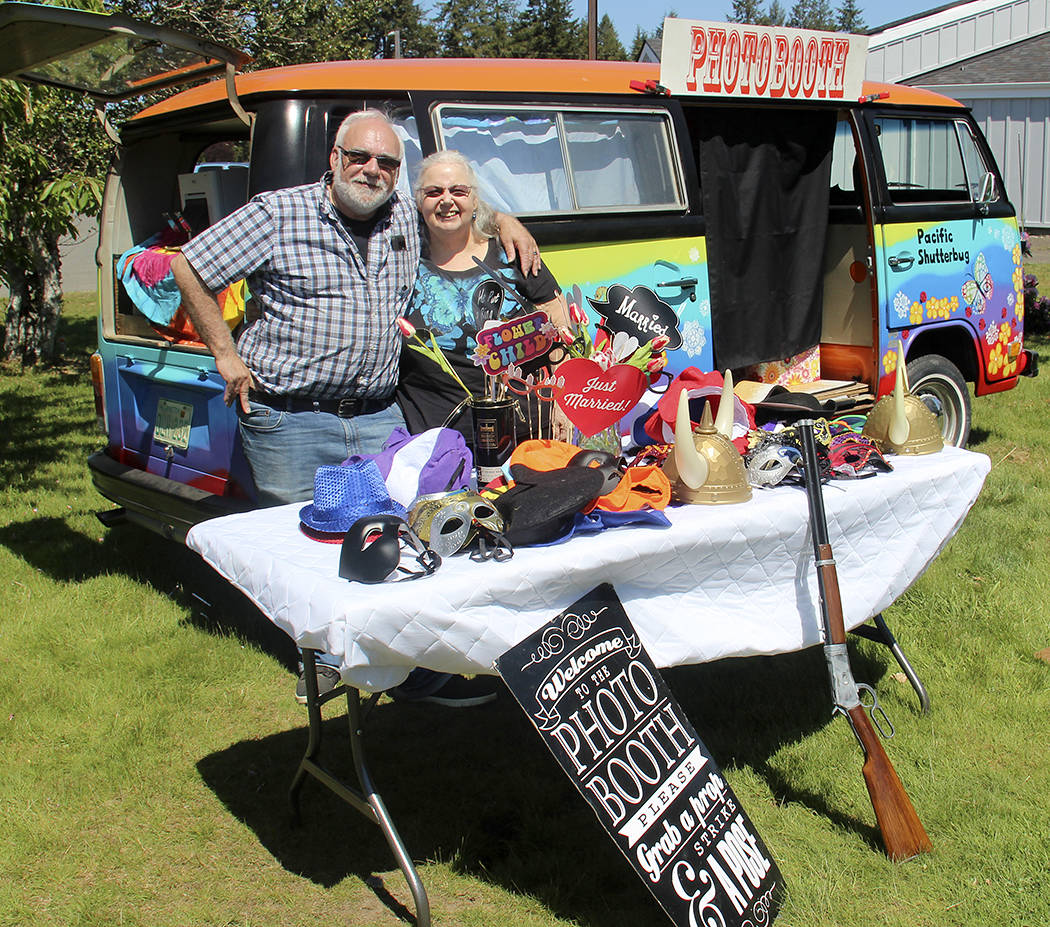 Bob with his wife Debbie stand outside the traveling photo booth. Bob has a variety of props or he will order props to fit the theme of the party/event.