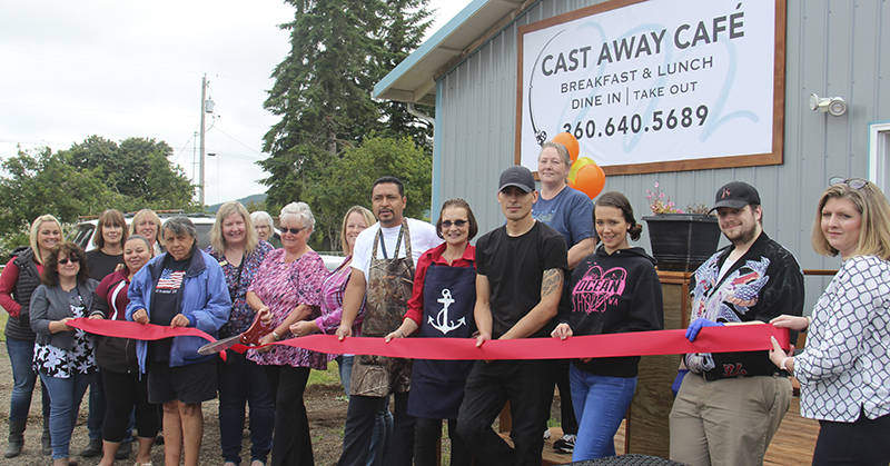 Linda Middleton, center with scissors, cuts the ribbon last Wednesday as the Cast Away Cafe opens for business. Photo Christi Baron