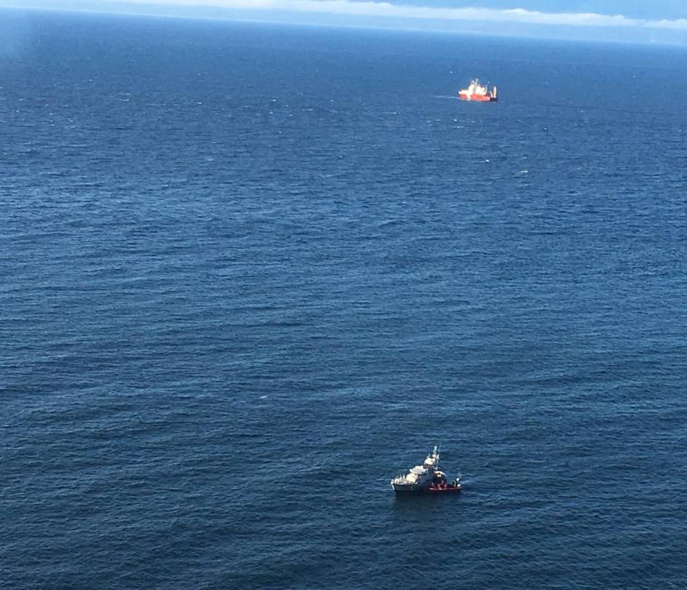 U.S., and Canadian Coast Guard crews rescue man from capsized vessel near Sekiu