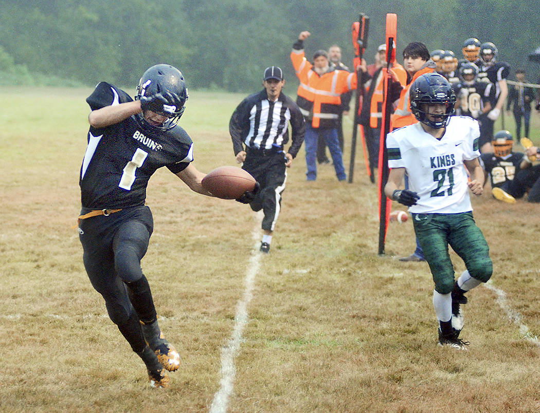 Clallam Bay senior quarterback Ryan Strid tiptoes to stay in bounds after breaking free from the Muckleshoot Tribal School defense for a second quarter touchdown on Friday during the Bruins’ 68-20 win. Photo by Mike Salsbury for the Forks Forum.