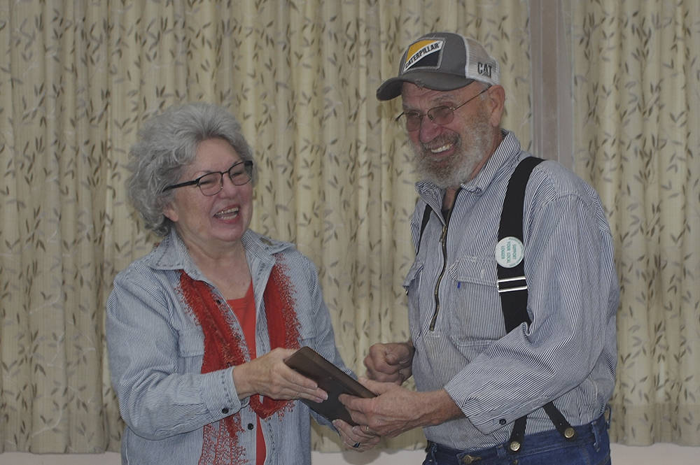 Forks Timber Museum Director Linda Offutt presents Richard Halverson with his 2019 Pioneer Logger Award plaque at the West End Business and Professional Association meeting on Wednesday morning at the Forks Congregational Church. Photo Lonnie Archibald