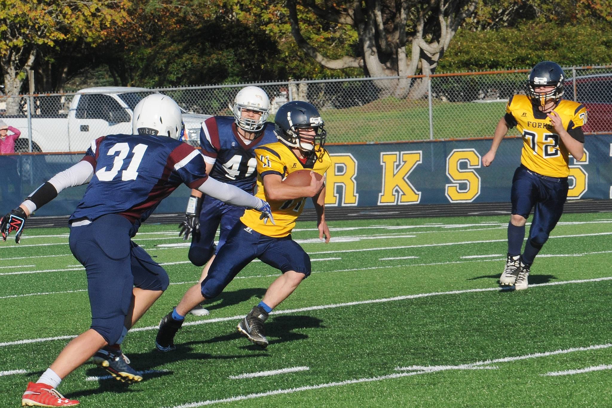 Forks Jr. High running back Walker Wheeler runs past Stevens’ defenders for a big gain during this game with the Stampeders at Spartan Stadium where Forks defeated Stevens 8-6. Also in on the action is Spartan Jacob Berry (72). Photo by Lonnie Archibald