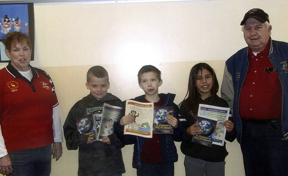 Forks Elks Lodge members Lynn Barnes left and Chuck Jennings far right with students Liam Miller, Christian Harding, and Xavier Soto who are representing third-grade classes at Forks Elementary. Submitted Photo