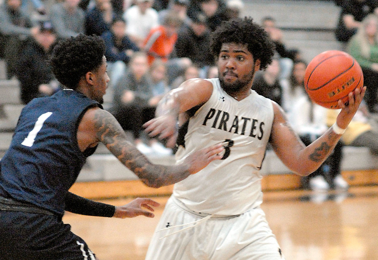 Peninsula’s Davien Harris-Williams prepares to pass as Bellevue’s Tijohn Rodde defends the lane in Port Angeles during a recent game. Harris-Williams has signed to play for the University of Providence Argonauts, an NAIA school in Great Falls, Mont. (Keith Thorpe/Peninsula Daily News file)