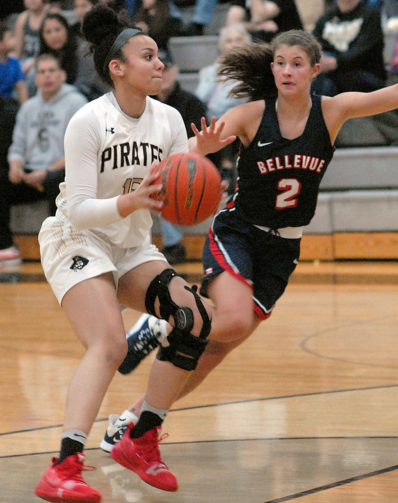 Peninsula’s Casandra White, left, slips past Bellevue’s Rokki Brown during a game in February. White has signed to continue her career at NCAA Division II Western Oregon University. (Keith Thorpe/Peninsula Daily News file)