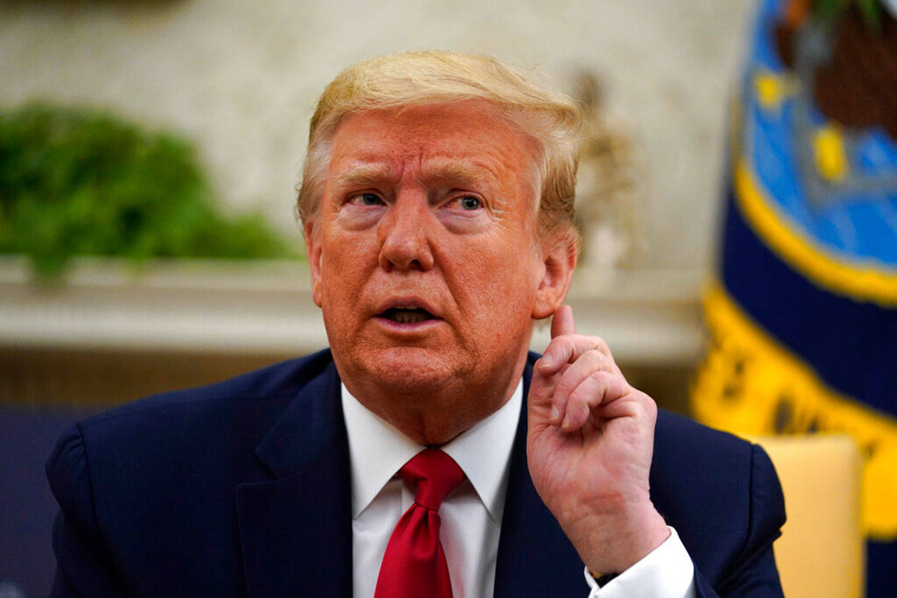 President Donald Trump listens during a meeting about the coronavirus with Gov. John Bel Edwards, D-La., in the Oval Office of the White House, Wednesday, April 29, 2020, in Washington. (Evan Vucci/Associated Press)