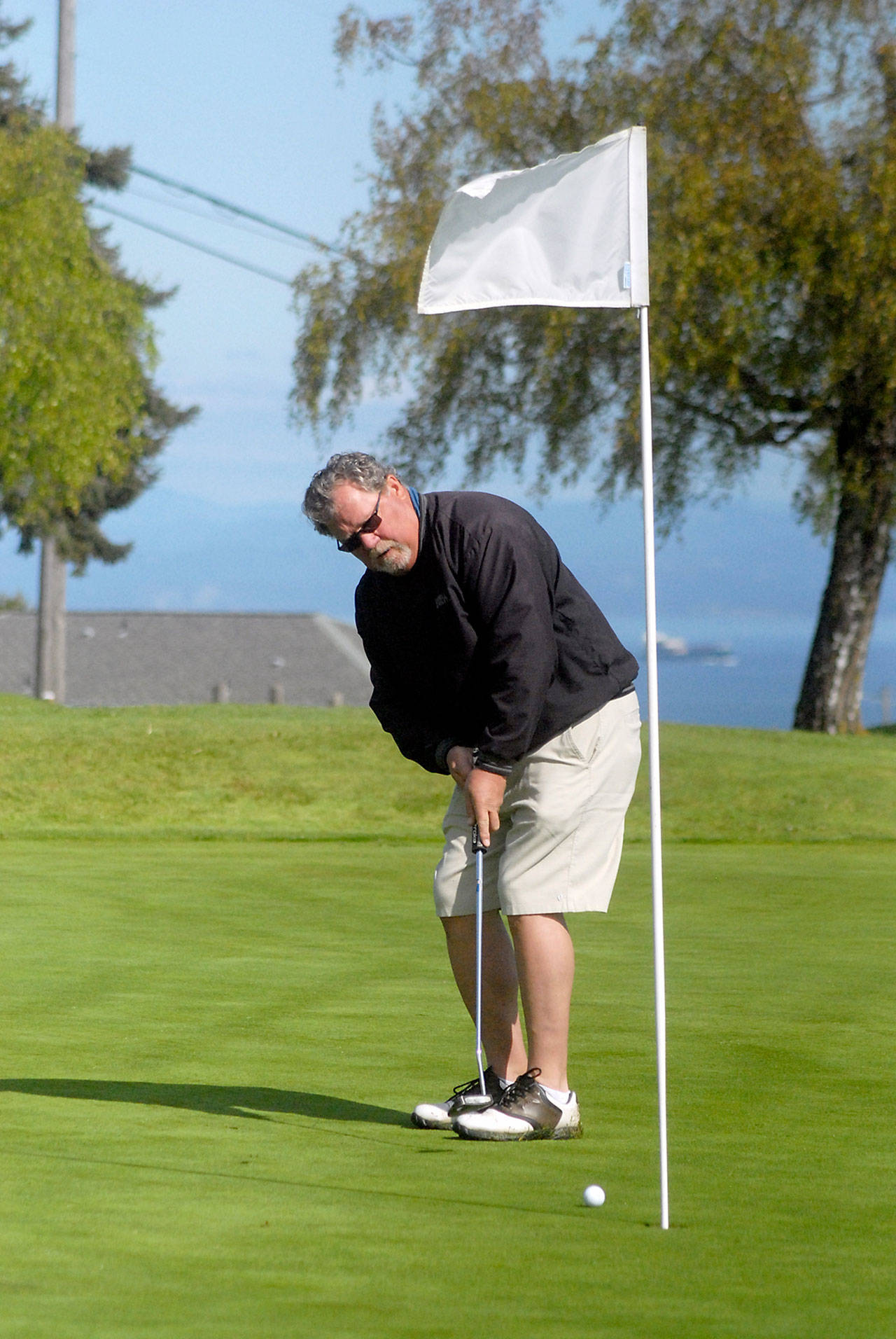Lawrence Bingham of Port Angeles putts at Peninsula Golf Course in Port Angeles on Tuesday, May 5, 2020, as golf courses around the state reopened for play. (Keith Thorpe/Peninsula Daily News)