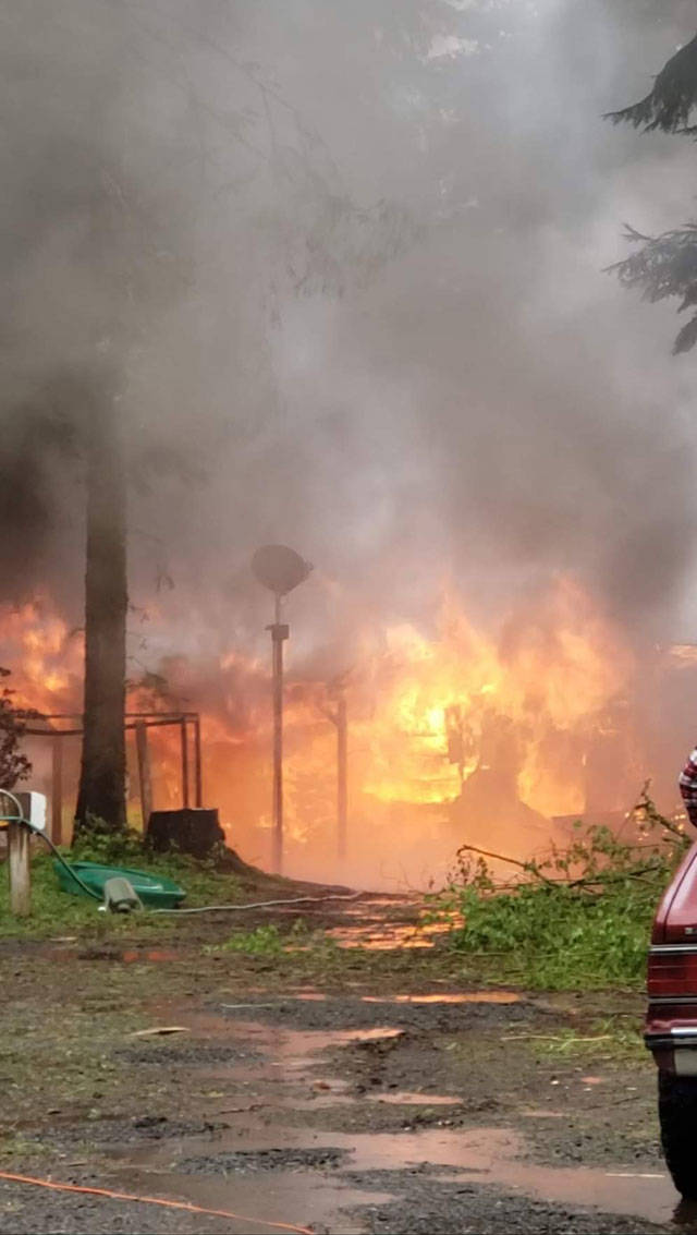 Flames shoot out of the bedroom of a Forks home Wednesday afternoon. (Clallam County Fire District 1)