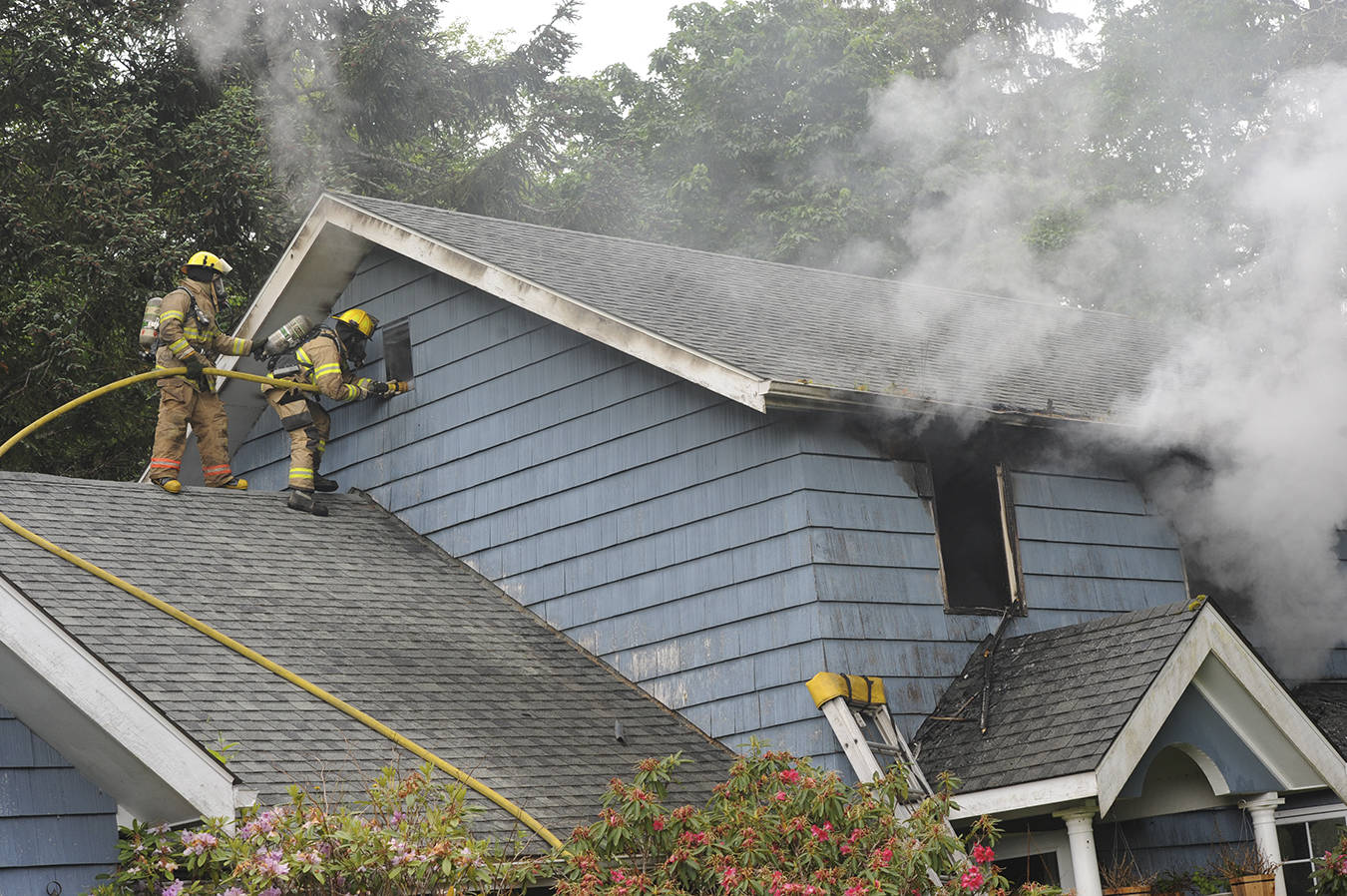 Firemen from District 1 fight a fire at the Peach home near MP 203 in Sappho at 5:30 p.m. Thursday, June 11. Law enforcement and Forks medics were also called to the scene. Photo by Lonnie Archibald