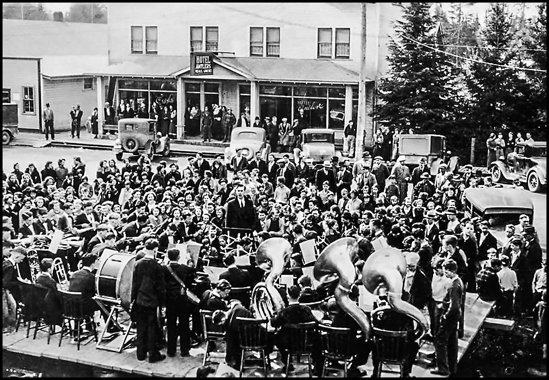QUHS band plays downtown Forks in front of the IOOF Hall and across the street from the Hotel Antlers.