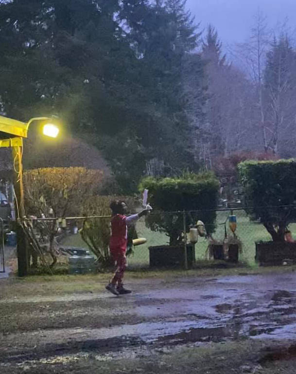 Ruth greeting Seahawks fans with her “I hate Seahawks” sign at her home on Sunday evening.