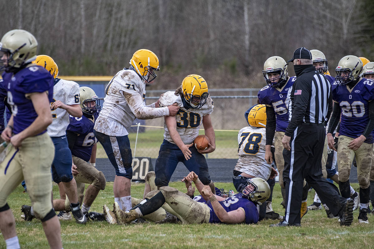 Spartan Sportsmanship - Senior Hayden Baker (#30) showing Spartan sportsmanship, as he extends a hand to help up an opponent during Saturday’s game at Onalaska. Photo by Kim Weissenfels, more photos page 9.