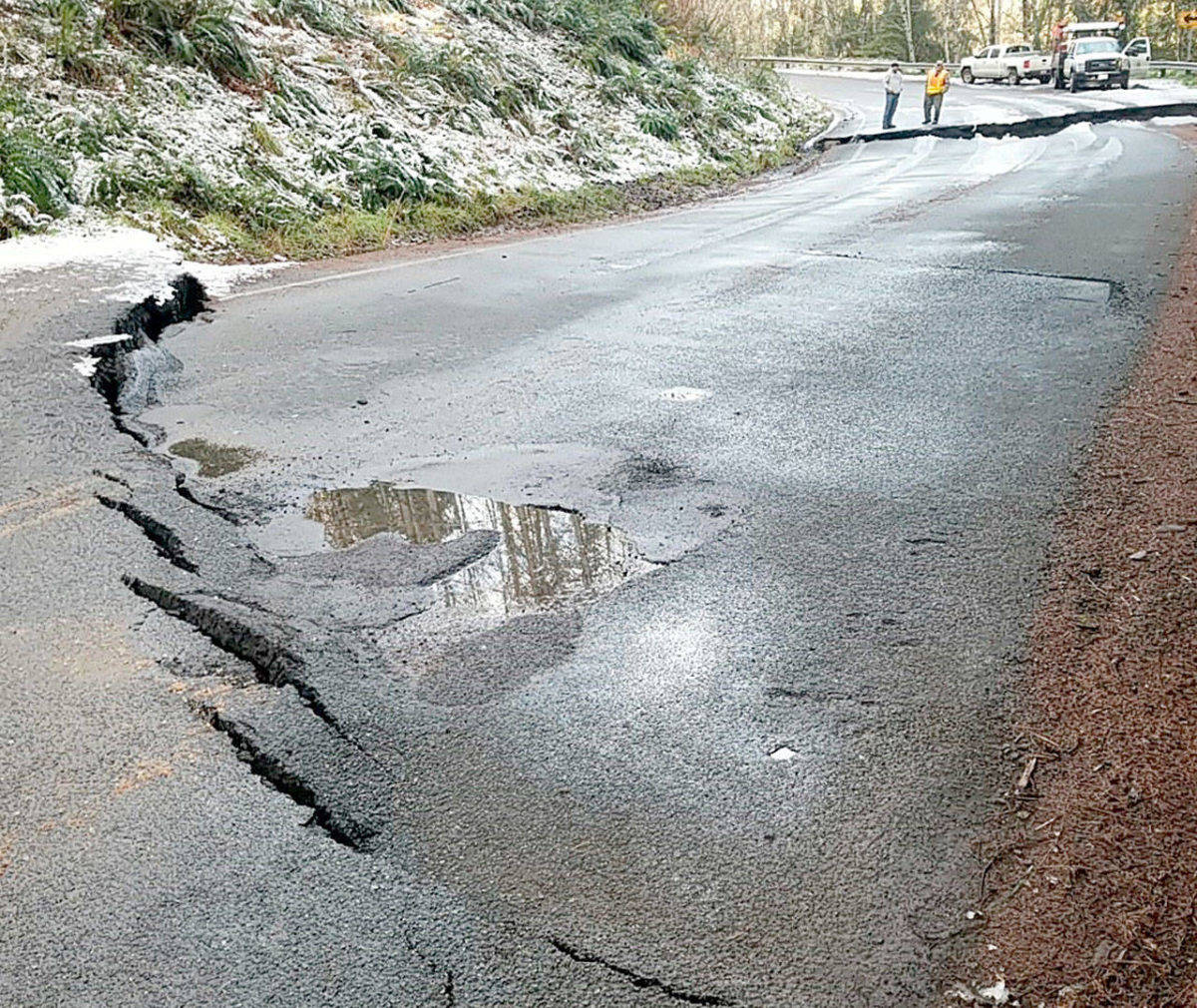State Department of Transportation crews inspect a sunken section of state Highway 112. (Photo courtesy of WSDOT)