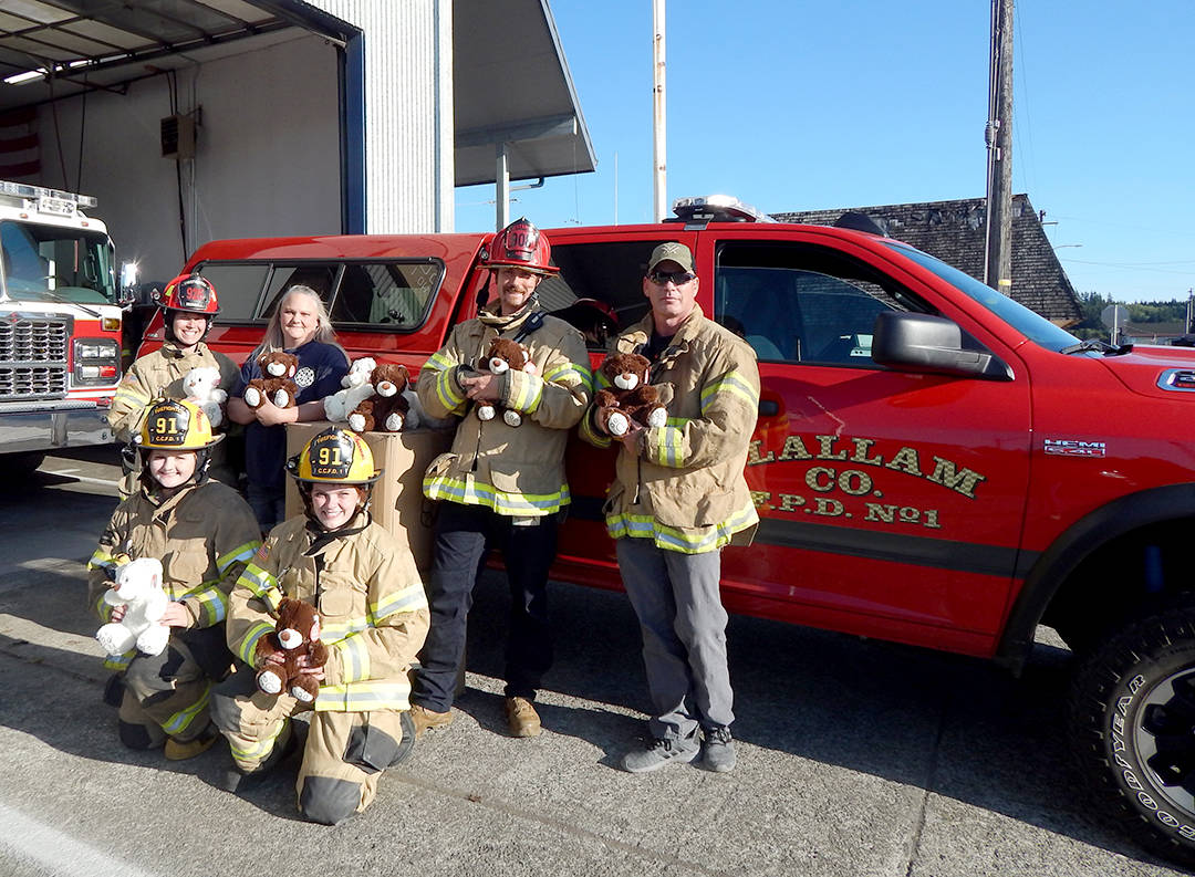 Seen here with just a few of the bears are (back) Lt. Avery Ironhill, Jamie Loushin, Lt. Nikolaus Ness, Chief Bill Paul; front Kyrissa Duncan and Emma Grayce Fleck. Photo Christi Baron