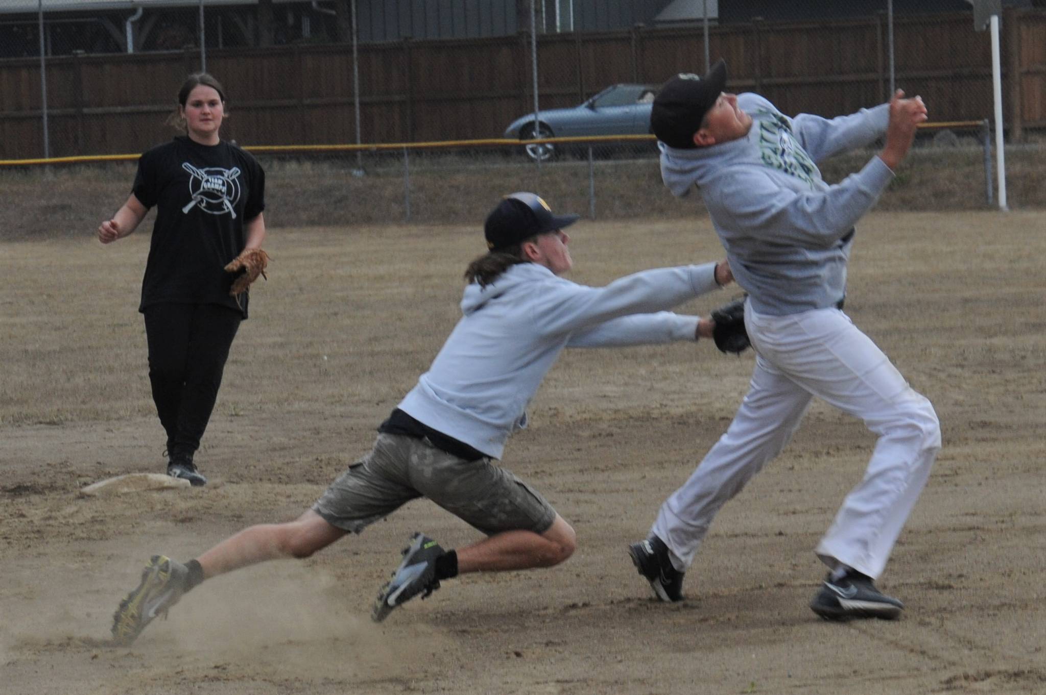Team Gramps shortstop Dalton Kilmer reaches in an attempt to tag Forks Merchant runner Tyler Penn out in Sunday’s game won by Team Gramps 16-10.