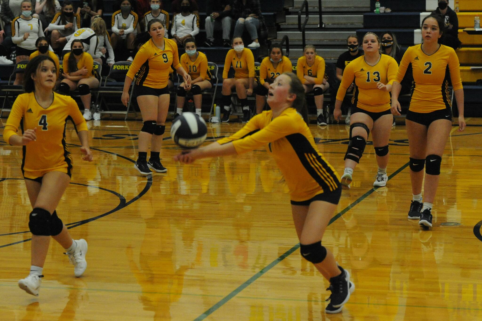 Forks’ Reagan Dunn hits while Catalina Armas (4), Morgan Rule (9), Nicole Winger (13), and Brynn Daniels (2) look on.