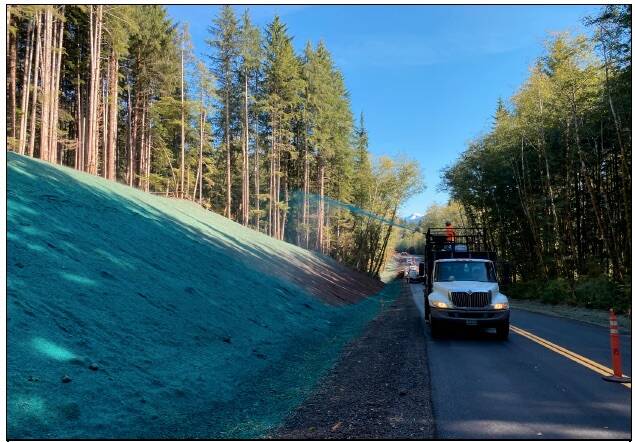 Spraying the hydroseed turf establishment at MP 10. This includes a native seed mix, fertilizer, mulch, and a biotic soil amendment. Source: FHWA