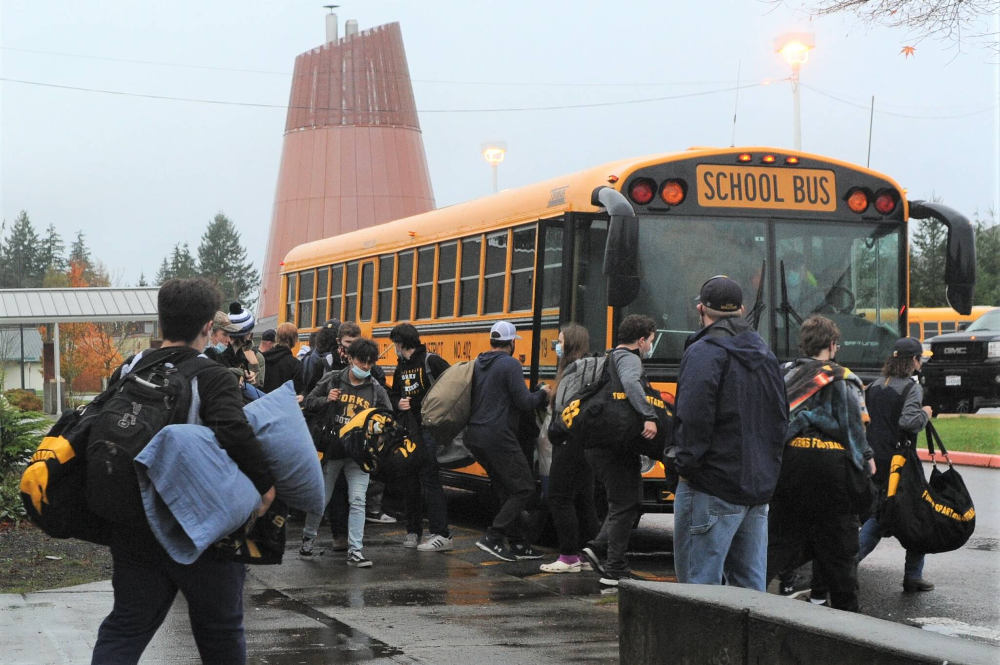 Spartans loading up Friday morning for the long bus ride to Goldendale, WA, but first, they cruised through downtown Forks. Photo Lonnie Archibald