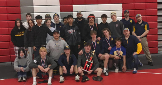 Courtesy of Forks High School The Forks boys and girls wrestling teams celebrate their second-and fourth-place trophies at the Tony Saldiver Invitational held in Granger on Saturday.