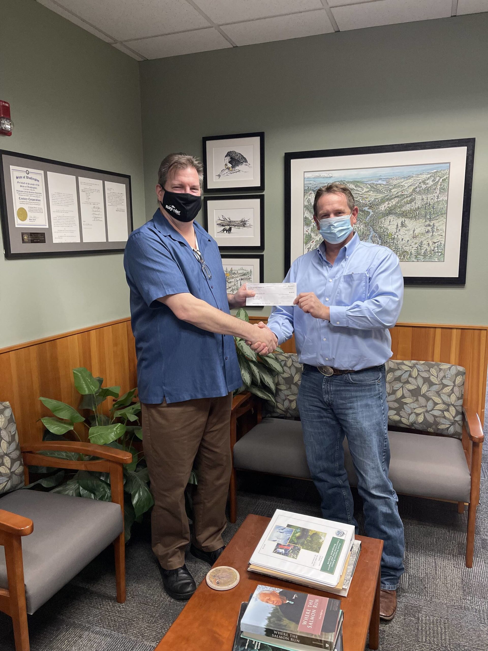 Bill Monahan, Director, Western Forest Resources for Rayonier presenting Jason Spadaro, WFPA Exec Dir, with a check for the Mark Doumit Scholarship Fund, to be managed by Pacific Education Institute.