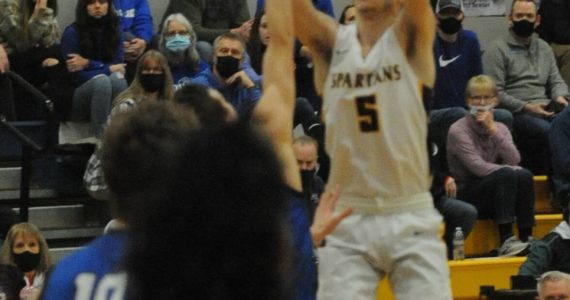 Spartan senior Ashton Doyle puts up a shot over Toutle Lake in this play-off contest won by Forks 71 to 66. Photo by Lonnie Archibald